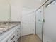 Elegant bathroom featuring double sinks, granite countertops, and a glass-enclosed shower at 503 Vigo St, Davenport, FL 33837