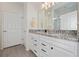 Modern bathroom with double vanity sinks, granite counters, and a glass door shower at 503 Vigo St, Davenport, FL 33837