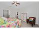 Bright bedroom features a cozy armchair, patterned bedding, and access to en-suite bathroom at 503 Vigo St, Davenport, FL 33837