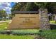 Welcoming entrance sign for The Forest community, featuring stone accents and lush landscaping at 503 Vigo St, Davenport, FL 33837