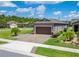 Well-maintained home featuring a paver driveway, mature landscaping, and an attached two-car garage at 503 Vigo St, Davenport, FL 33837