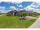 Beautifully landscaped home with a paver driveway, a tropical palm, and a manicured lawn at 503 Vigo St, Davenport, FL 33837