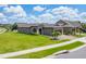 Beautiful home on a lush green lawn with a paver driveway, complemented by mature palm trees at 503 Vigo St, Davenport, FL 33837
