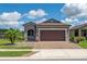 Charming single-story home with a well-manicured lawn, paver driveway, and a two-car garage at 503 Vigo St, Davenport, FL 33837