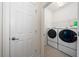 Clean laundry room featuring modern washer and dryer units, and tile flooring at 503 Vigo St, Davenport, FL 33837