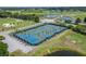 Aerial view of well-maintained tennis courts surrounded by palm trees and lush greenery at 503 Vigo St, Davenport, FL 33837