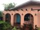 Charming home entrance with stucco arches, wrought iron details, and a colorful front door at 507 Bates Ave, Eustis, FL 32726