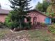 Home exterior featuring a covered entryway, garage, and colorful landscaping at 507 Bates Ave, Eustis, FL 32726