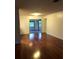 Spacious living room features gleaming hardwood floors and access to outdoor patio at 507 Bates Ave, Eustis, FL 32726