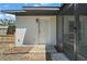 Back door entrance featuring a simple exterior door and neutral-toned siding at 525 Oak Dr, Tavares, FL 32778