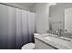 Modern bathroom featuring a shower with curtain and a vanity with granite countertop at 525 Oak Dr, Tavares, FL 32778