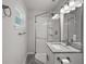 Bathroom features a tile and glass shower, granite counters and new vanity lighting at 525 Oak Dr, Tavares, FL 32778
