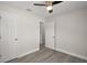 Bedroom features neutral paint, a ceiling fan, wood-look floors and multiple closets at 525 Oak Dr, Tavares, FL 32778