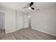 Bedroom features neutral paint, a ceiling fan, wood-look floors, and an ensuite bathroom at 525 Oak Dr, Tavares, FL 32778