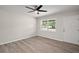 Cozy bedroom with modern floors, a ceiling fan, and a window, offering a peaceful retreat at 525 Oak Dr, Tavares, FL 32778