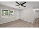 Bright bedroom with modern floors, a ceiling fan, and a large window with natural light at 525 Oak Dr, Tavares, FL 32778