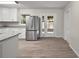 Updated kitchen featuring stainless steel appliances, white cabinets, granite countertops, and backyard access at 525 Oak Dr, Tavares, FL 32778