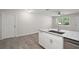 Updated kitchen island sink featuring granite countertops, and modern fixtures, perfect for cooking and entertaining at 525 Oak Dr, Tavares, FL 32778