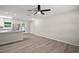 Bright living room featuring modern floors, an updated ceiling fan, and an open concept design at 525 Oak Dr, Tavares, FL 32778