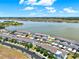 Aerial view of blue townhomes next to a beautiful lake with trees at 534 Juniper Springs Dr, Groveland, FL 34736