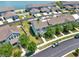 Aerial view of charming townhomes near a lake with curbside parking at 534 Juniper Springs Dr, Groveland, FL 34736