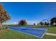 Well-maintained basketball court for recreational activities, set against a clear blue sky in a lush green community at 534 Juniper Springs Dr, Groveland, FL 34736