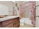 Well-maintained bathroom features vanity, granite countertop, tiled floors and shower with curtain at 534 Juniper Springs Dr, Groveland, FL 34736