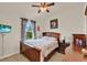 This bedroom features a ceiling fan, wood furniture, a large window, and lots of natural light at 534 Juniper Springs Dr, Groveland, FL 34736