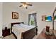The bedroom features wood furniture, ceiling fan and large window for natural light at 534 Juniper Springs Dr, Groveland, FL 34736