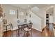 Dining area with hardwood floors, a glass top table, and decorative wall art at 534 Juniper Springs Dr, Groveland, FL 34736