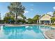 Inviting community pool featuring comfortable lounge chairs, a clear blue pool, and manicured landscaping for relaxation at 534 Juniper Springs Dr, Groveland, FL 34736
