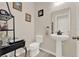 Stylish powder room with pedestal sink, neutral walls, and decorative shelving at 534 Juniper Springs Dr, Groveland, FL 34736