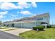 Townhomes with garages and driveways offer ample parking space on a beautiful sunny day at 534 Juniper Springs Dr, Groveland, FL 34736