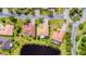 An aerial view showing a home with lush backyard landscaping and a view of a nearby pond at 537 Montage Ln, Kissimmee, FL 34759