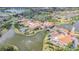 Aerial shot featuring a community building surrounded by a beautiful pond, palm trees, and manicured landscaping at 537 Montage Ln, Kissimmee, FL 34759