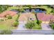 Aerial view of the beautiful home showcasing its tile roof, backyard pond, and mature landscaping at 537 Montage Ln, Kissimmee, FL 34759