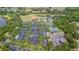 Aerial view of a parking lot next to tennis and baseball courts and surrounded by lush greenery and lakes at 537 Montage Ln, Kissimmee, FL 34759