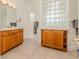 Bathroom featuring tiled floors, wooden cabinets and an unusual glass block feature for privacy and light at 537 Montage Ln, Kissimmee, FL 34759