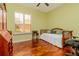 The bedroom is arranged as an office with natural light from a large window and hardwood floors at 537 Montage Ln, Kissimmee, FL 34759