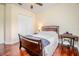 Bright bedroom featuring hardwood floors, ceiling fan and good natural light from large window at 537 Montage Ln, Kissimmee, FL 34759