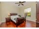 Well-lit bedroom features hardwood floors and a large window with view of the neighborhood at 537 Montage Ln, Kissimmee, FL 34759