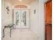 Welcoming foyer with stylish tile flooring, glass topped table, and views through glass entry doors at 537 Montage Ln, Kissimmee, FL 34759