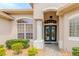 Close up of the home's entrance featuring double doors with decorative glass and detailed transom window at 537 Montage Ln, Kissimmee, FL 34759