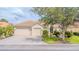 Charming single-story home with a paved driveway, mature landscaping, and a tile roof at 537 Montage Ln, Kissimmee, FL 34759