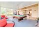 Bright game room with a pool table, seating, and access to the home's living area at 537 Montage Ln, Kissimmee, FL 34759