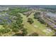 Aerial view of a lush golf course with mature trees interspersed throughout a residential neighborhood at 537 Montage Ln, Kissimmee, FL 34759