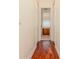 Hallway features wood floors and leads to bathroom featuring unique glass block window feature at 537 Montage Ln, Kissimmee, FL 34759