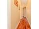 Bright hallway with light-yellow walls and hardwood flooring throughout at 537 Montage Ln, Kissimmee, FL 34759