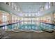 Bright indoor pool area with large windows, ample seating, and clear water for year-round enjoyment at 537 Montage Ln, Kissimmee, FL 34759