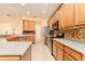 Well-lit kitchen features stainless steel appliances, granite countertops, tiled backsplash and light wood cabinets at 537 Montage Ln, Kissimmee, FL 34759